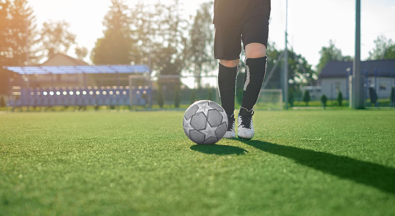 kid kicking soccer ball