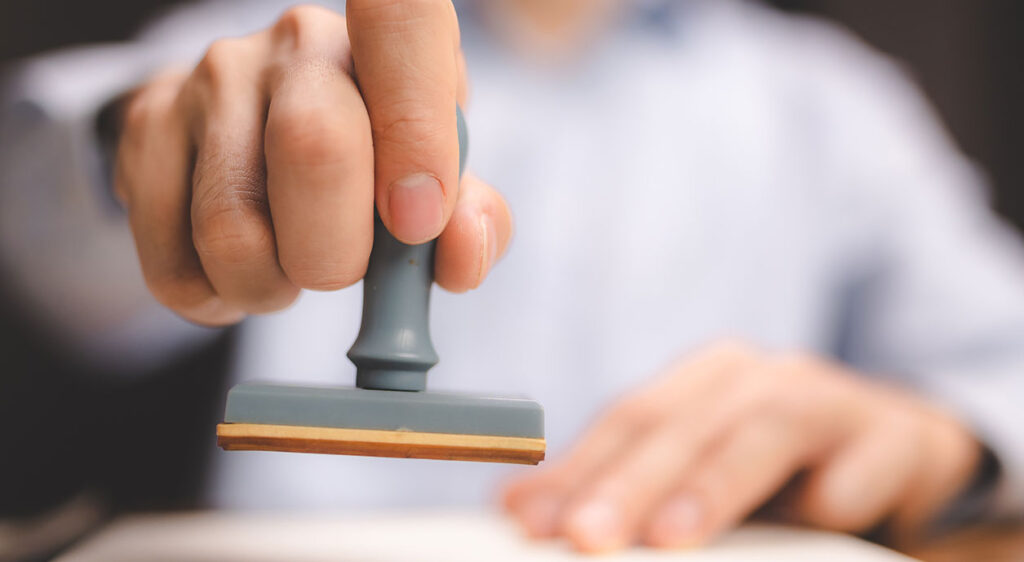 man stamping a paper