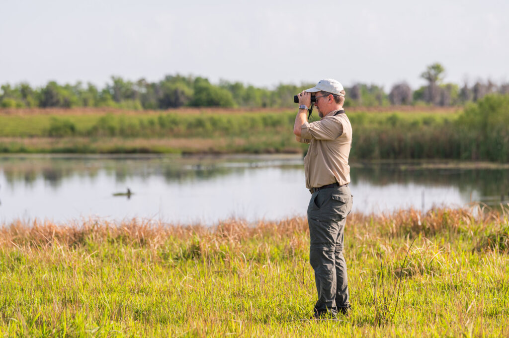 Polk County TAG Member with binoculars scouting land