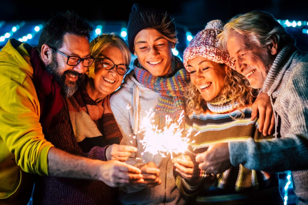 group of friends gathered around using sparklers
