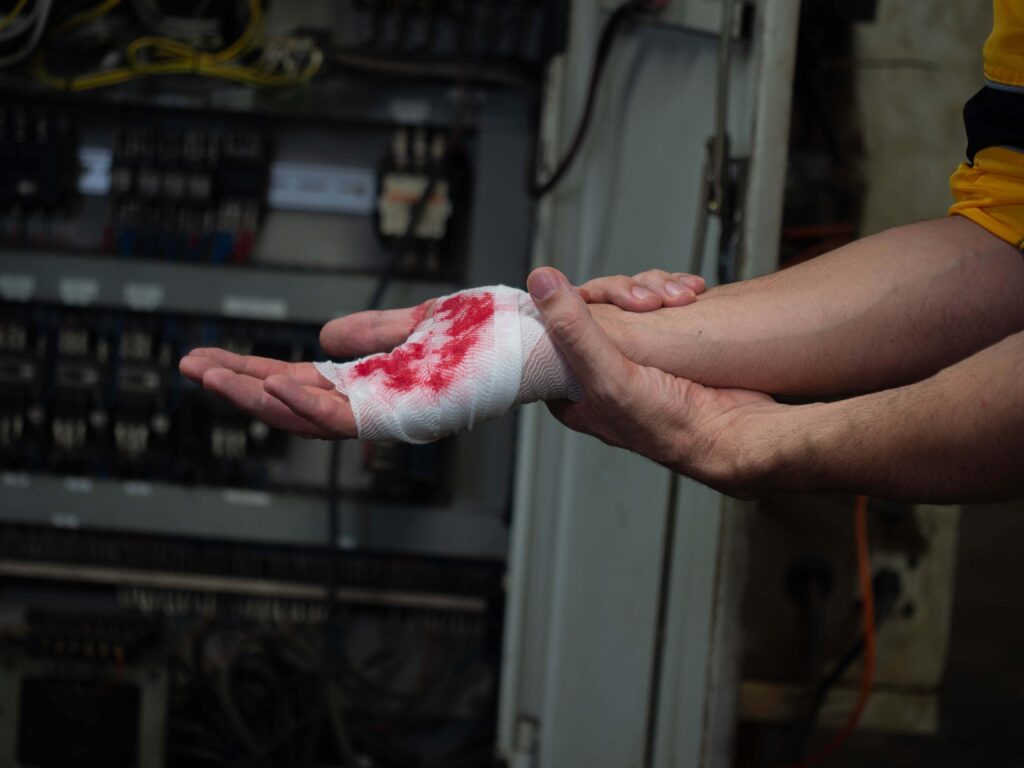 man with bandage on bleeding hand