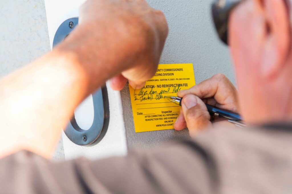 Polk building inspector signing violation sticker