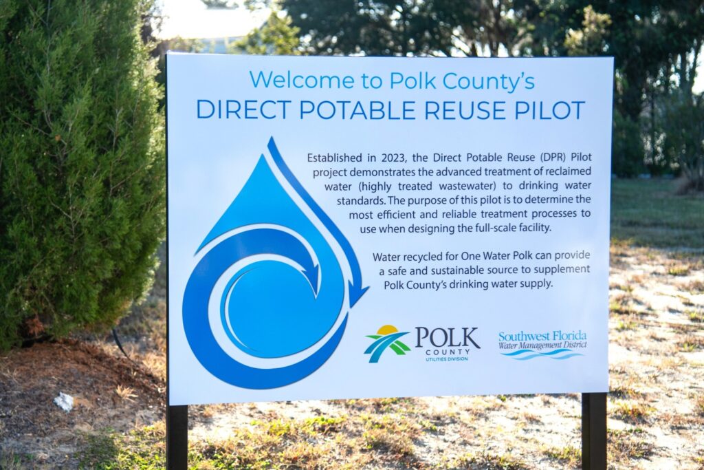 white sign welcoming visitors to polk county's direct potable reuse pilot facility