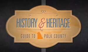 Vintage-style sign reading “History & Heritage: Guide to Polk County,” with an orange silhouette of Florida on a tan background.